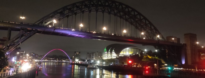 Nighttime view of the Tyne and Gateshead Millenium Bridges.